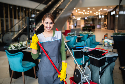 Beautiful young woman cleaning at shopping mall